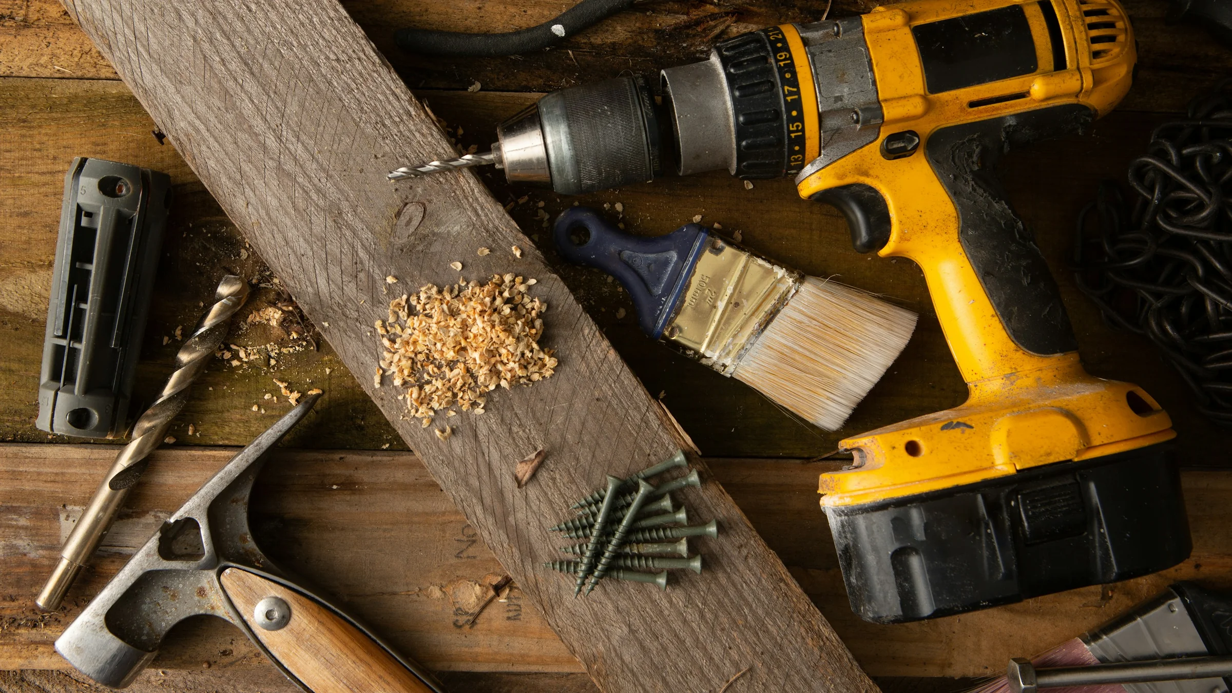 Woodworking and flooring tools laid out on wood